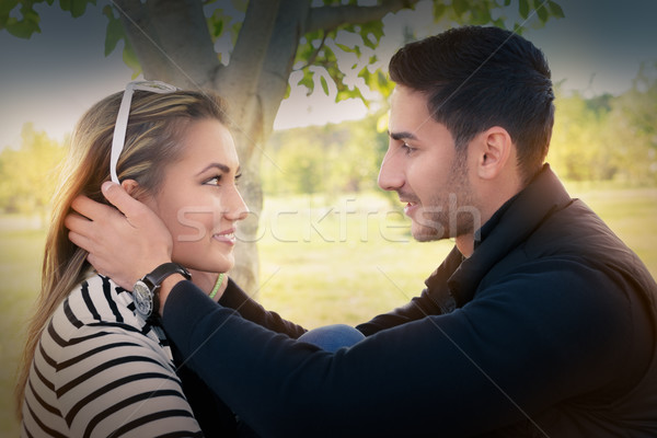 Stock photo:  Young couple in love looking in each other’s eyes