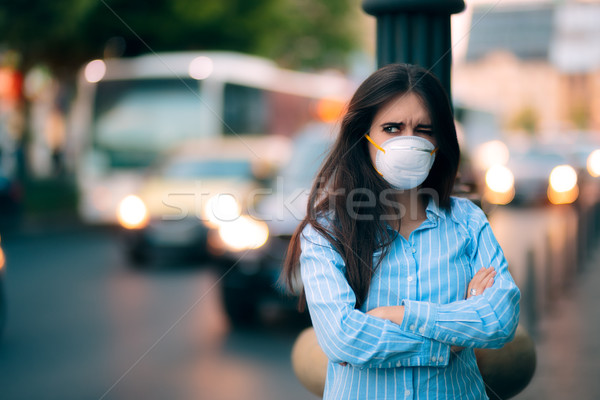 Woman With Respiratory Mask Out in Polluted City  Stock photo © NicoletaIonescu