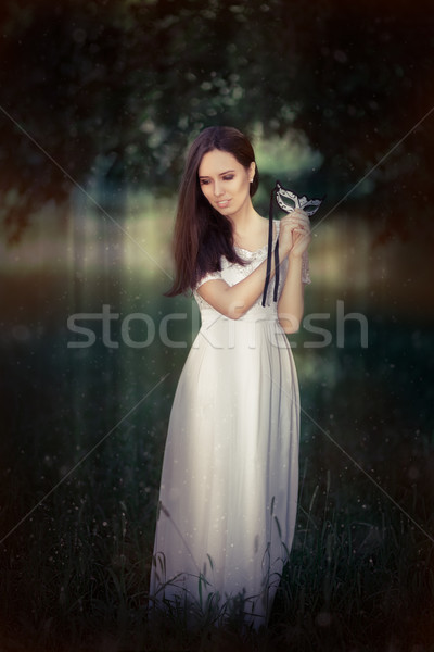 Stock photo: Young Woman in Long White Dress Wearing Mask 