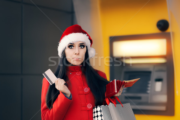 [[stock_photo]]: Noël · femme · portefeuille · banque · atm · drôle
