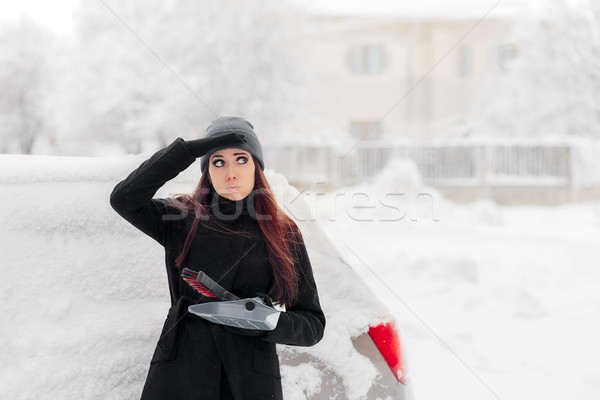Girl with Brush and Shovel Removing Snow from the Car Stock photo © NicoletaIonescu