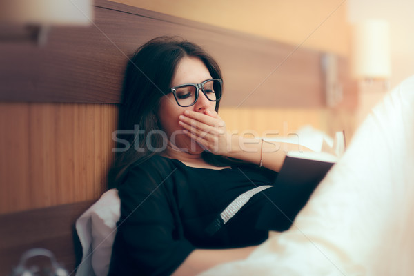 Tired Woman Reading Book in Bed before Sleep Stock photo © NicoletaIonescu