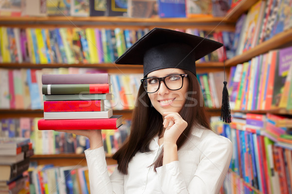 Happy Student with Graduation Cap Holding Books Stock photo © NicoletaIonescu