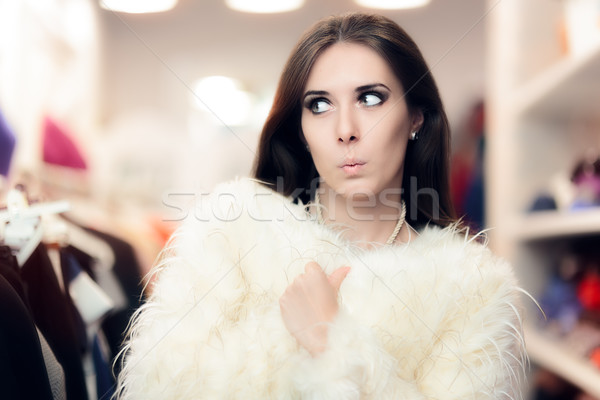 Curious Woman Wearing White Fur Coat in Fashion Store Stock photo © NicoletaIonescu