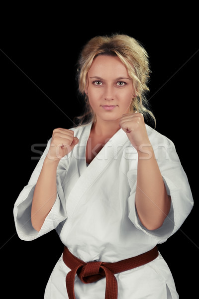 Young Karate Woman Wearing Kimono in Martial Art Pose  Stock photo © NicoletaIonescu