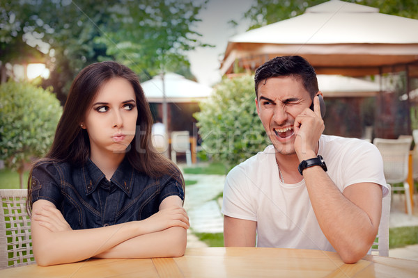 Girl Feeling Bored while her Boyfriend is on The Phone Stock photo © NicoletaIonescu