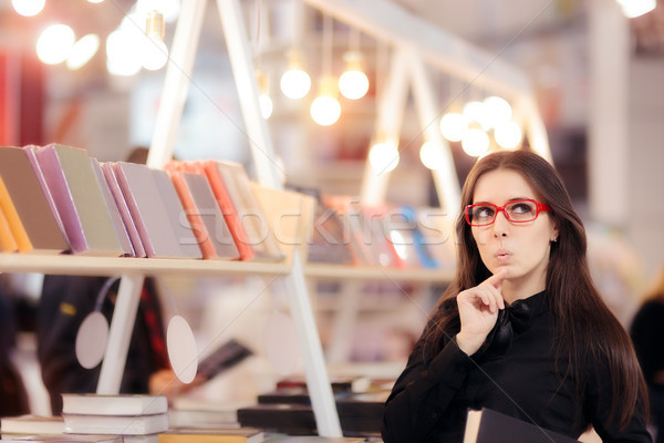 Curious Student Girl Thinking what Books to Buy Stock photo © NicoletaIonescu