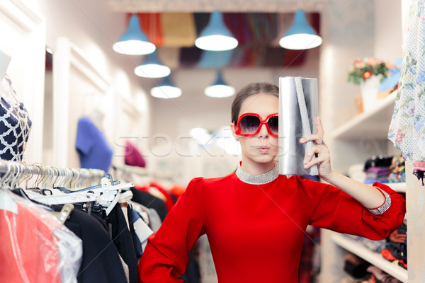Funny fashion woman in red dress with big glasses and shinny bag Stock photo © NicoletaIonescu