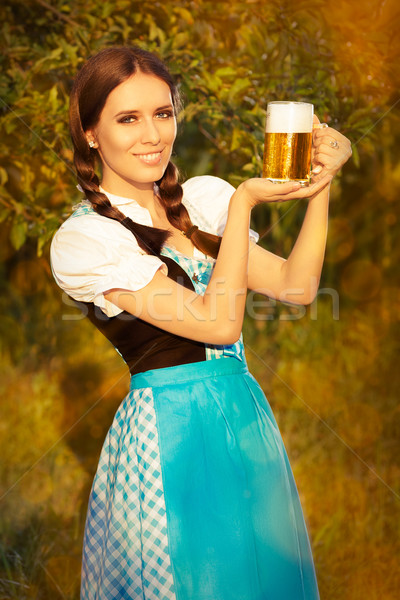 Young Bavarian Woman Holding Beer Tankard  Stock photo © NicoletaIonescu