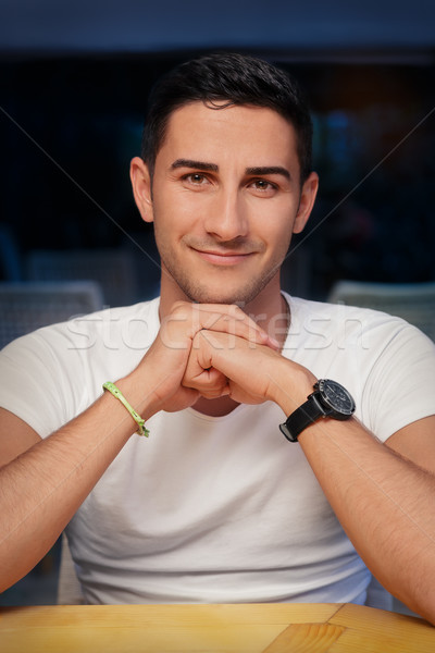 Young Man Sitting in a Restaurant Stock photo © NicoletaIonescu