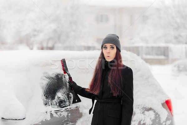 Funny Woman with a Brush Removing Snow from Car Stock photo © NicoletaIonescu