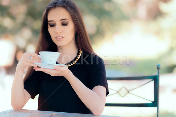 Beautiful Woman with Statement Necklace Having a Cup of Coffee  Stock photo © NicoletaIonescu