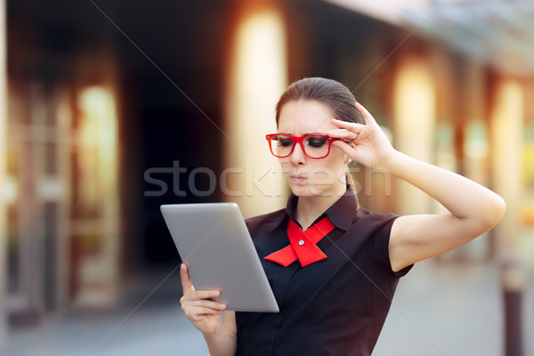 Discontent Businesswoman with Pc Tablet and Red Glasses Stock photo © NicoletaIonescu