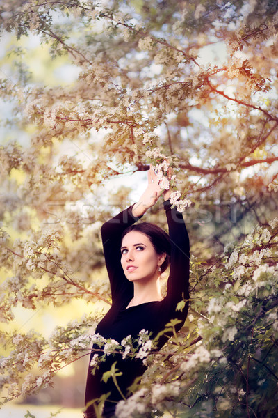 Beautiful Graceful Woman in Spring Blossom Enjoying the Flowers Stock photo © NicoletaIonescu
