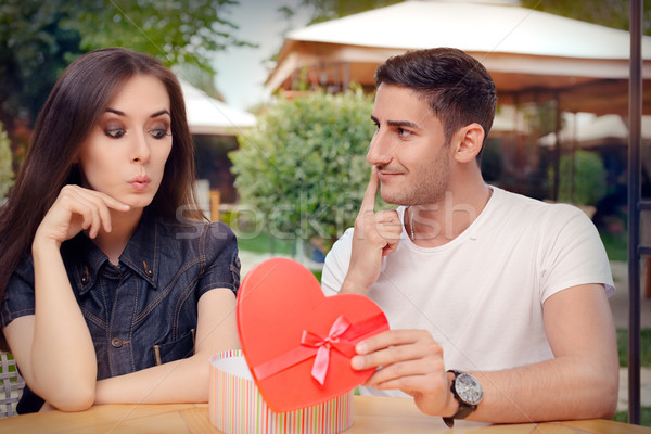 Surprised Girl Receiving Heart Shaped Gift from her Boyfriend  Stock photo © NicoletaIonescu