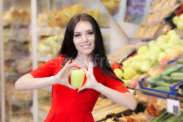 Stock photo: Woman with Green Pepper Shopping for Groceries in a Supermarket