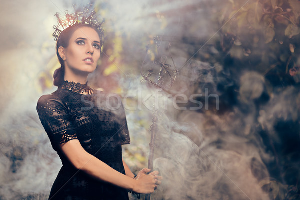 Evil Queen Holding Scepter in Misty Forest Stock photo © NicoletaIonescu