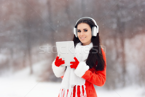 Happy Winter Girl with Headphones and PC Tablet Stock photo © NicoletaIonescu