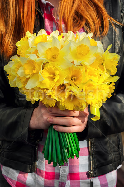 figure girl with bouquet of daffodils in his hands Stock photo © nikolaydonetsk