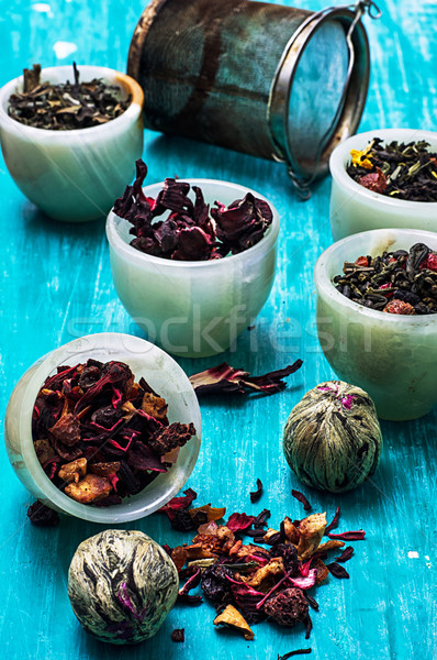 variety of dry tea leaves in jade stacks on wooden background Stock photo © nikolaydonetsk