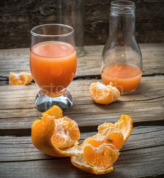 fresh juice of tropical citrus fruits on wooden background Stock photo © nikolaydonetsk