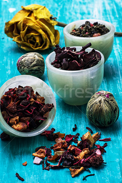 variety of dry tea leaves in jade stacks on wooden background Stock photo © nikolaydonetsk