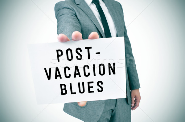 man in suit shows a signboard with the text post-vacation blues, Stock photo © nito
