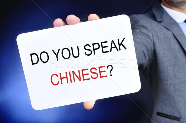 man showing a signboard with the question do you speak chinese? Stock photo © nito