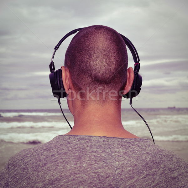 young man listening to music  in front of the sea, filtered Stock photo © nito