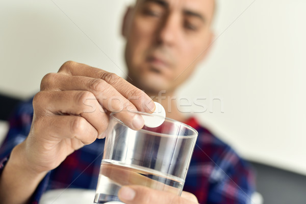 man putting an effervescent tablet into a glass with water Stock photo © nito