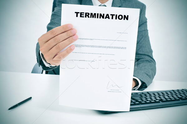 man in suit showing a figured signed termination document Stock photo © nito