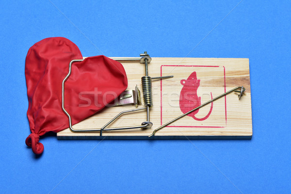 deflated heart-shaped balloon in a mousetrap Stock photo © nito