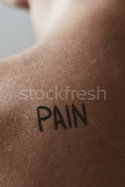man with the word pain in his back Stock photo © nito