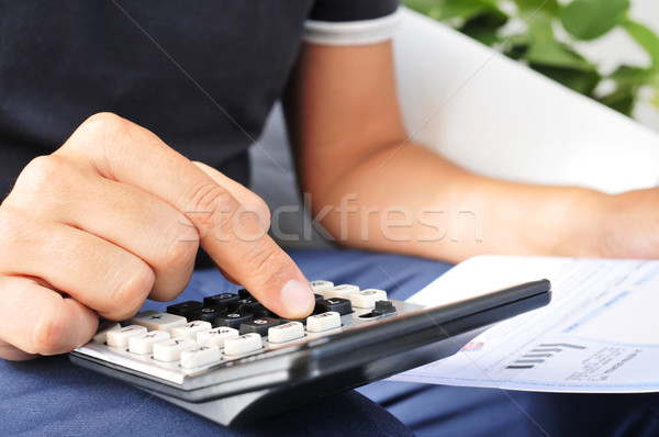 young man checking a bill, a budget or a payroll Stock photo © nito