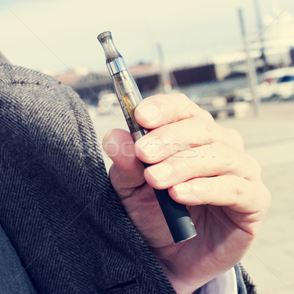 man vaping with an electronic cigarette outdoors Stock photo © nito