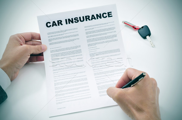 man signing a car insurance policy Stock photo © nito