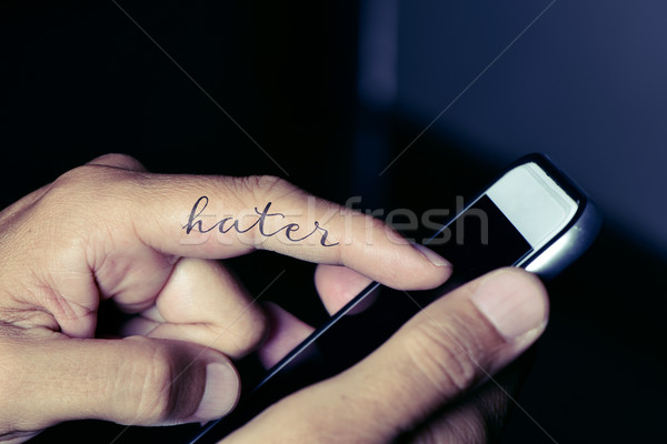 hater man using a smartphone Stock photo © nito