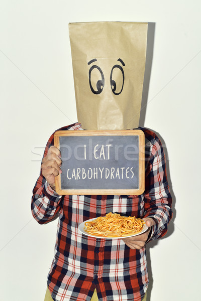 man with chalkboard with text I eat carbohydrates Stock photo © nito
