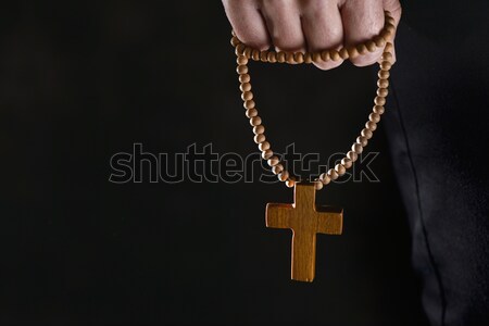 Stock photo: young man with a rosary in his hand