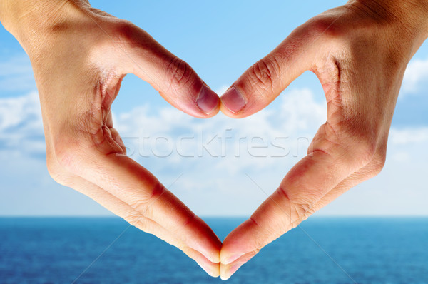 Serca człowiek ręce ocean niebo miłości Zdjęcia stock © nito
