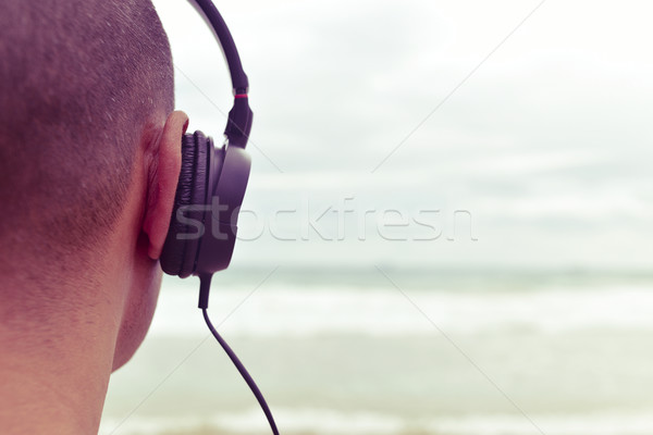 young man listening to music  in front of the sea, filtered Stock photo © nito