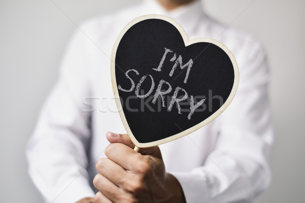 man with a signboard with the text I am sorry Stock photo © nito