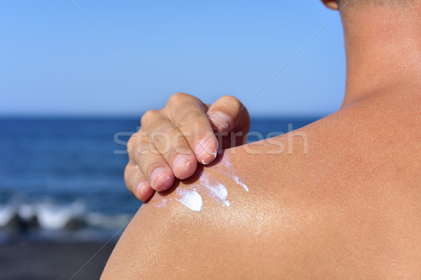 man applying sunscreen to his back Stock photo © nito