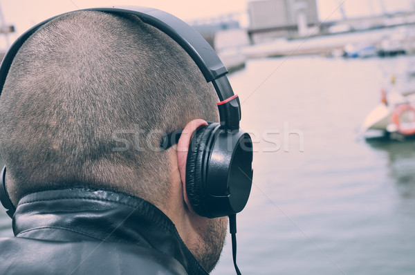 young man listening to music in front of the sea, filtered Stock photo © nito