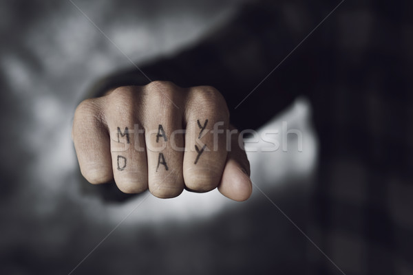 Stock photo: text may day in the fist of a man
