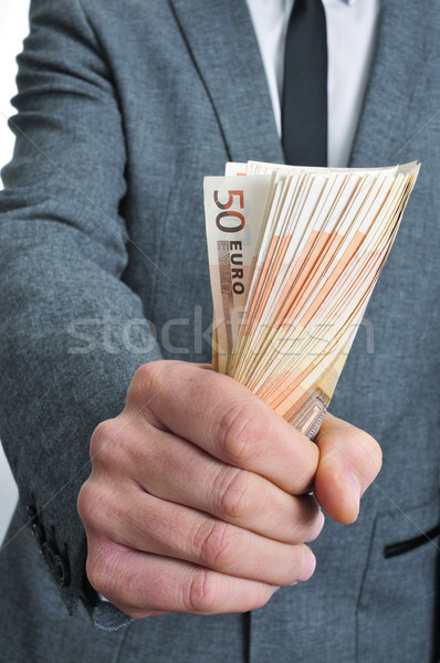 man in suit with a wad of euro bills Stock photo © nito