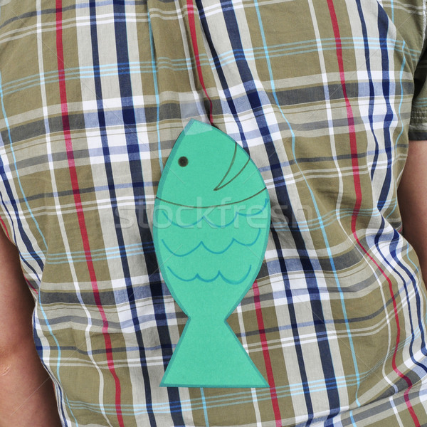 young man with a paper fish attached to his back Stock photo © nito