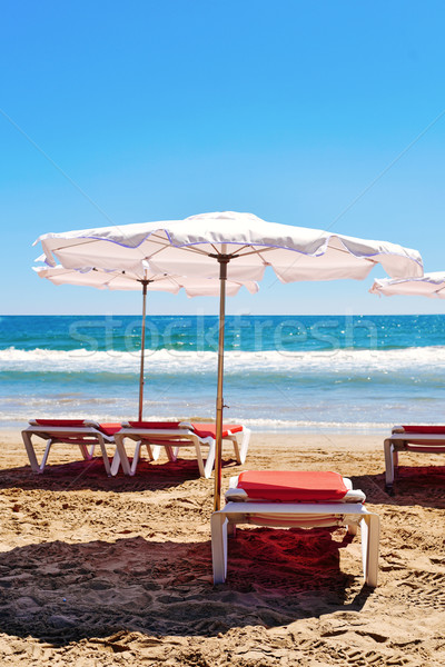 sunloungers and umbrellas in a quiet beach Stock photo © nito
