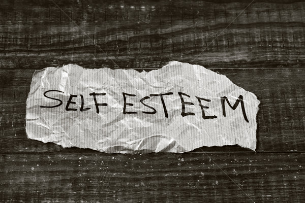 Stock photo: text self esteem written in a piece of paper