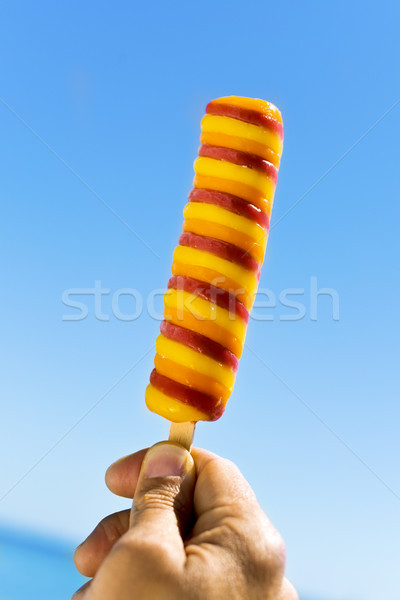 young man eating a refreshing popsicle Stock photo © nito